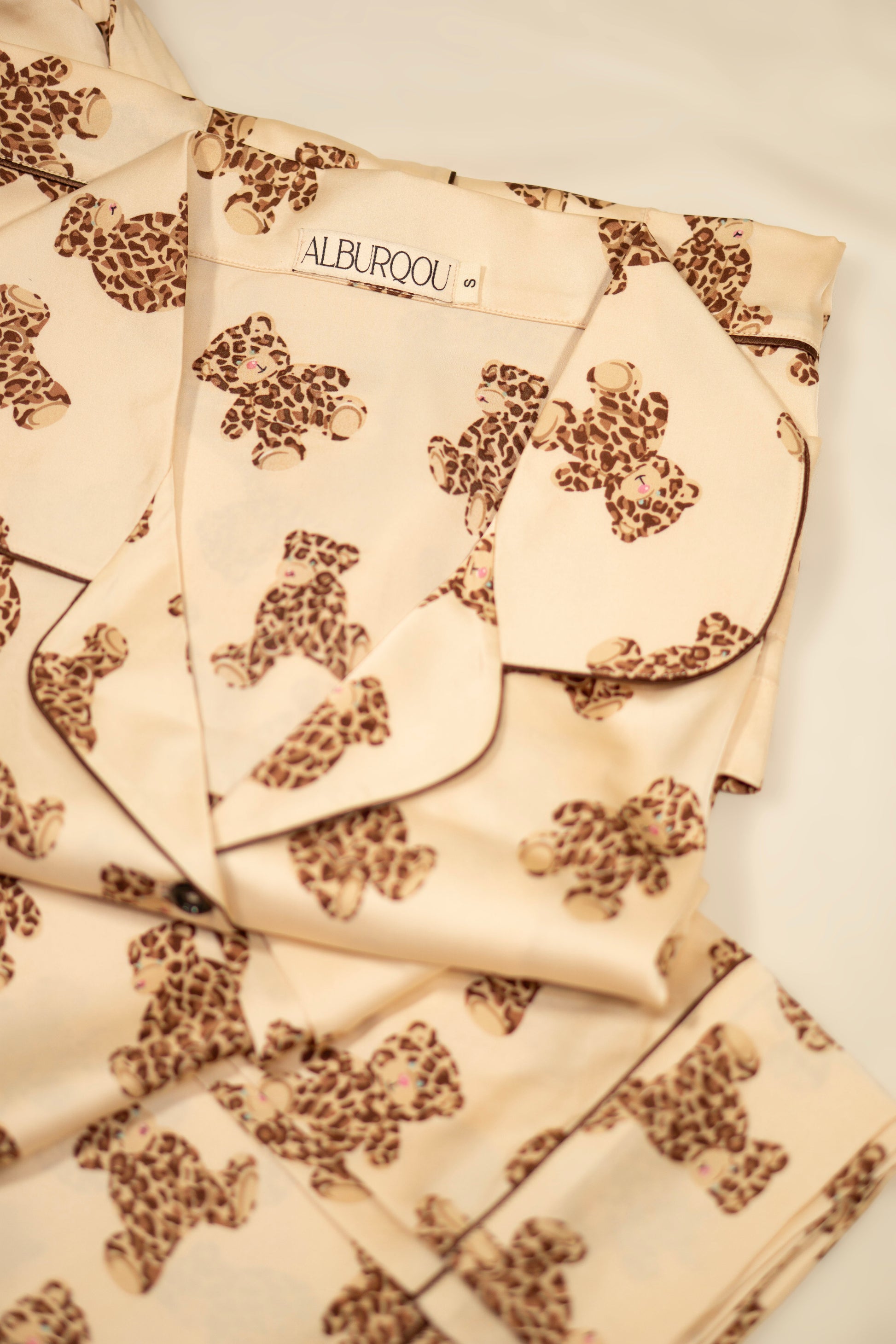 ALBURQOU's Premium Satin Beige PJs with Leopard printed Teddy Bears consists of pajama shirt with collar, short-sleeves and button-down top, the PJ pants are wide-leg with elastic band
