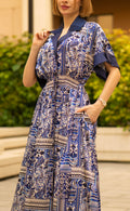 Blue bohemian printed maxi shirt dress for women with button-down front and modest silhouette, the dress shirt has a solid colour collar and sleeve cuffs. The dress also consist of pockets!