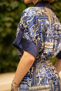 Blue bohemian printed maxi shirt dress for women with button-down front and modest silhouette, this picture shows the short sleeve with sleeve cuffs and button details. The dress also consist of pockets.
