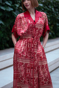 Red bohemian printed maxi shirt dress for women with button-down front and modest silhouette, the dress shirt has a solid colour collar and sleeve cuffs. The dress also consist of pockets!