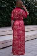 Back view of Red bohemian printed maxi shirt dress for women with button-down front and modest silhouette, the dress shirt has a solid colour collar and sleeve cuffs. The dress also consist of pockets!
