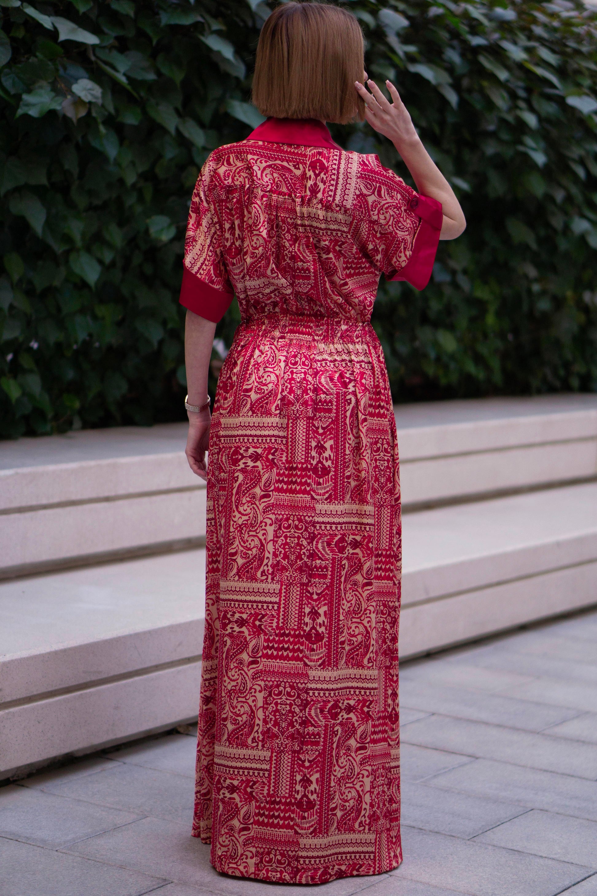 Back view of Red bohemian printed maxi shirt dress for women with button-down front and modest silhouette, the dress shirt has a solid colour collar and sleeve cuffs. The dress also consist of pockets!