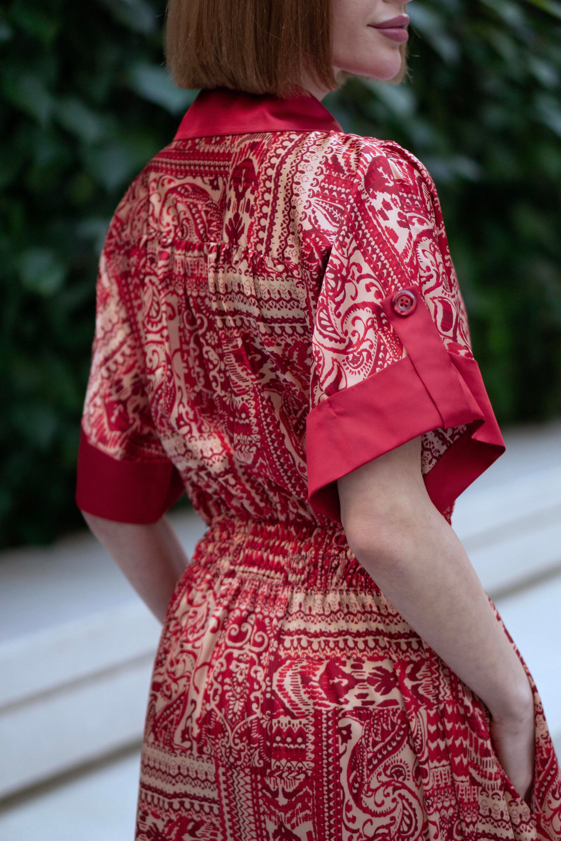 Back view of Red bohemian printed maxi shirt dress for women with button-down front and modest silhouette, the dress shirt has a solid colour collar and sleeve cuffs. The dress also consist of pockets!