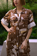 Printed brown shirt dress with side slits, women’s full-length button-down shirt dress featuring artistic script print and short sleeves