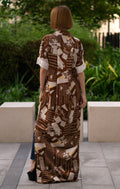 Back view of the printed brown shirt dress with side slits, women’s full-length button-down shirt dress featuring artistic script print and short sleeves