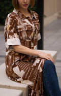 Printed brown shirt dress with side slits, women’s full-length button-down shirt dress featuring artistic script print and short sleeves