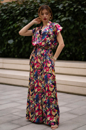 Women wearing a retro V-neck A-line maxi dress with bold printed design. The dress also consist of pockets!