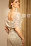 Back view of beige cowl evening dress with silver sequins and draped neckline